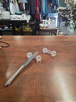 Knife rests on tabletop with dinner knife for scale
