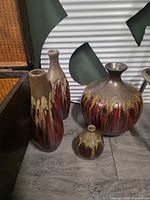 All four ceramic vases grouped together showing sizes and glaze