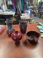 Four studio pottery pieces on table