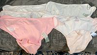All six swaddle wraps laid out showing colors and quantity