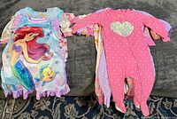 Group view of entire baby sleepwear lot on sofa
