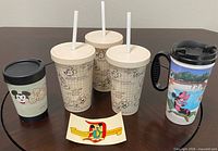 Overview of five drinkware pieces and decal