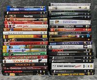 Full overview of two stacks of DVD and Blu-ray cases on table