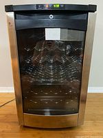 Front view showing entire wine cooler, stainless frame, glass door, digital display