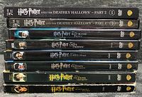 Spines of all eight Harry Potter DVDs stacked, titles and wear visible