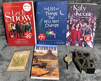 All items in lot: four books standing, watch, bookmark, metal LOVE sculpture