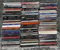 Four tall stacks of CD jewel cases showing album spines