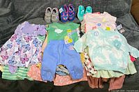 Overview of all clothing and three pairs of shoes on surface