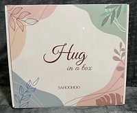 Front of sealed SAHOOHOO Hug in a Box packaging