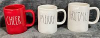 Front view of three mugs showing text designs