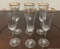 Six faceted crystal cordial glasses standing on table