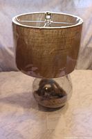 Lamp with one burlap shade installed, plastic wrap visible