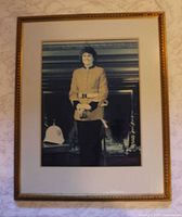 Full view of framed portrait on wall