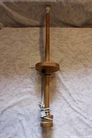 Full view of wooden pole with cord and circular joint