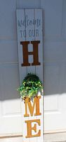 Full view of wood HOME welcome sign with wreath