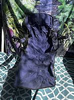Front view of navy folding lounge chair showing full length and cup holder