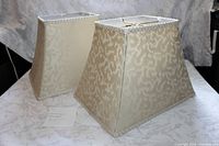 Both rectangular beige ivory fabric lamp shades, exterior view