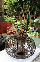 Full view of rattan centerpiece with glass insert and dried reeds