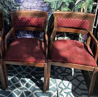 Front angle of two armchairs showing fabric, arms and legs