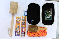 All items displayed including open case, loofah, toothbrush packs, hairbrush, pouch