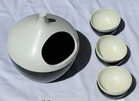 Salt pig and three spice dishes on white cloth