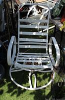 Front view of white metal rocking swivel chair showing slatted seat/back and circular base