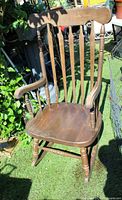 Front angled view of Windsor solid wood rocking chair showing full structure, spindle back, armrests and rockers