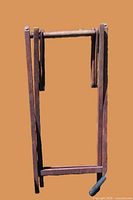 Dark brown wood folding director chair frame folded upright