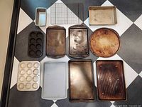 Overview showing all eleven bakeware pieces arranged on floor