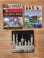Front covers of the three books displayed on wooden surface