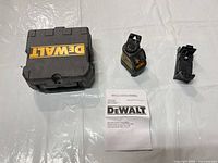 Laser level, case, bracket and manual laid out