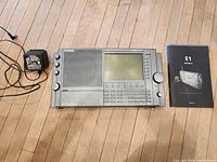 Radio, AC adapter, and manual laid out on floor