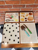 Top view of all four cutting boards and two cheese tools