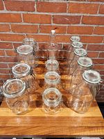 All 13 glass jars and bottle arranged on table