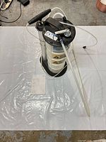 Entire fluid evacuator with hoses and manual