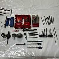 Overview of all drill bits, hole saw, wire brushes, Kreg jig and accessories on table