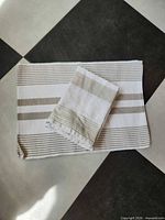 One placemat with folded napkin showing stripe pattern and texture