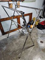 Full view of stainless steel folding garment rack set up