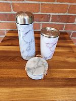 Bottle, tumbler, stacked coasters in holder showing overall lot