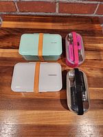 Four bento boxes closed showing colours and bands