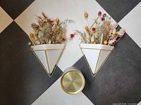 Two Umbra Trigg wall planters with dried florals and Umbra Tesora jewellery box closed