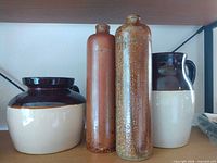 Crock, pitcher and both brown bottles side by side