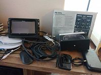 Lot overview showing Pioneer head unit, Gemini mixer box, 8BitDo controller box, mouse, discs and cables