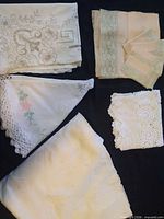Assorted folded tablecloths, napkins and runners overall view
