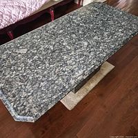 Full view of granite coffee table showing top and pedestal base