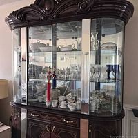 Front view of large mahogany china cabinet with glass doors and shelves