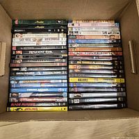 Box containing two columns of stacked DVD cases