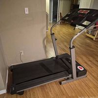 Side view of Weslo treadmill showing frame, belt and console