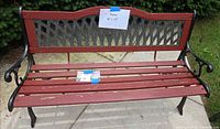 Front view of red wood slat bench with black cast iron frame