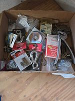 Top view of cardboard box showing all assorted hardware and hand tool